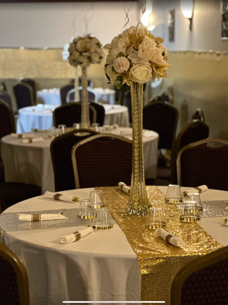 Round tables with tall gold centerpieces
