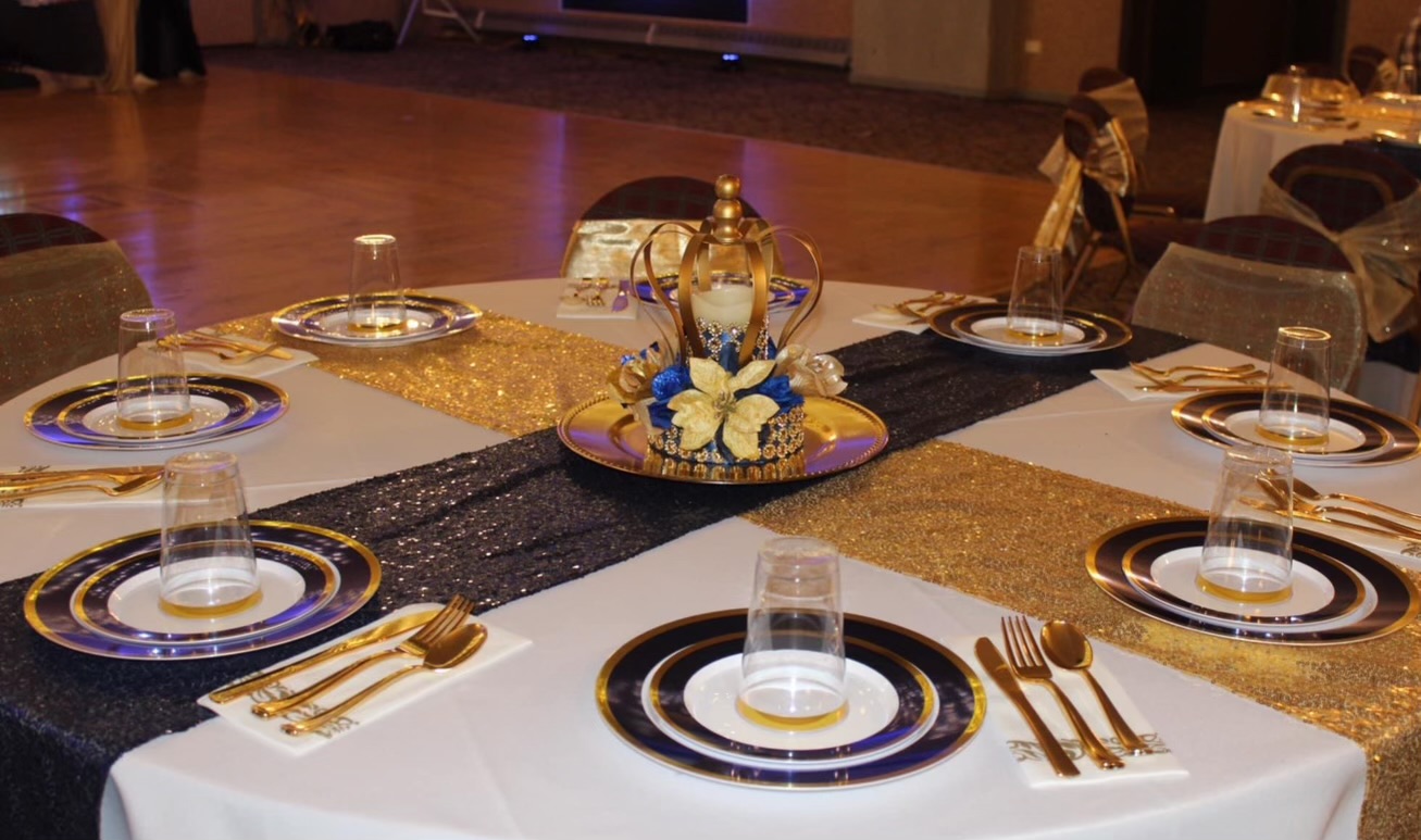 Gold and navy table setting with crown centerpiece