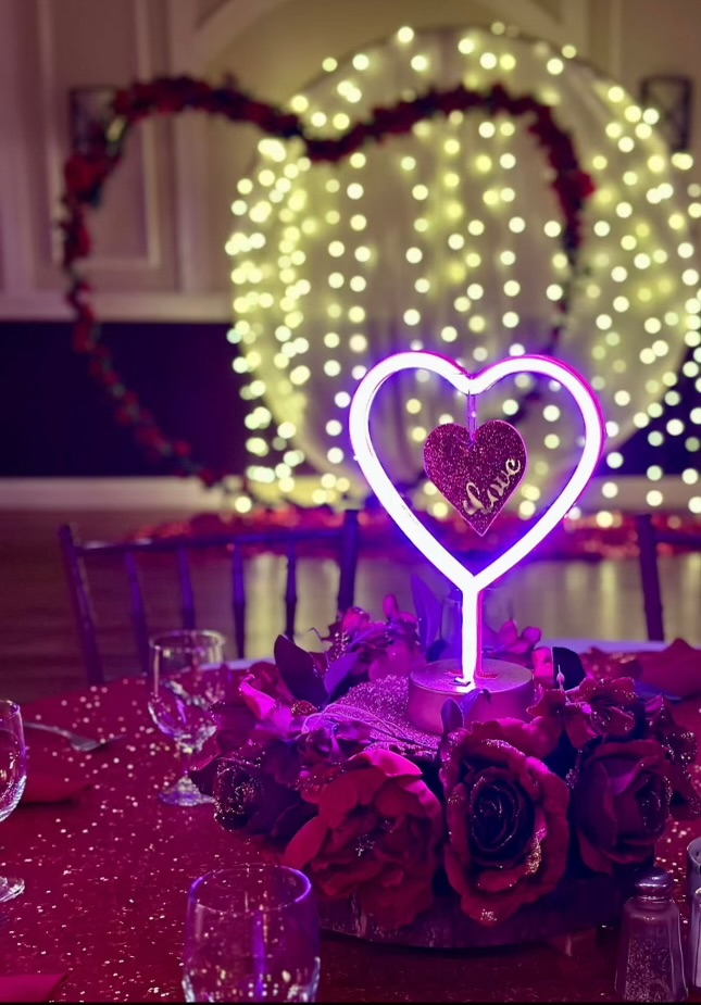 Violet heart centerpiece with roses on red table